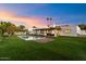 Stunning backyard showcasing a pristine pool and lush lawn at 8014 E Del Tesoro Dr, Scottsdale, AZ 85258