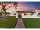 Charming single-story home with a welcoming front porch and landscaped yard at 8014 E Del Tesoro Dr, Scottsdale, AZ 85258