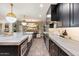 Modern kitchen with a large island, stylish backsplash, and stainless steel appliances at 8014 E Del Tesoro Dr, Scottsdale, AZ 85258