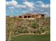 Luxury estate home nestled on a hillside with desert landscaping at 9808 E Honey Mesquite Dr, Scottsdale, AZ 85262