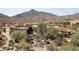 Luxury estate home with circular design, situated on a hillside overlooking a golf course and mountain views at 9808 E Honey Mesquite Dr, Scottsdale, AZ 85262