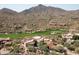 Luxury home on golf course with mountain views in the background at 9808 E Honey Mesquite Dr, Scottsdale, AZ 85262