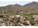 Luxury estate home with circular design, situated on a hillside overlooking a golf course and mountain views at 9808 E Honey Mesquite Dr, Scottsdale, AZ 85262