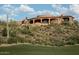 Luxury estate home nestled on a hillside with desert landscaping at 9808 E Honey Mesquite Dr, Scottsdale, AZ 85262