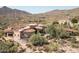 Luxury estate home with circular design, situated on a hillside overlooking a golf course and mountain views at 9808 E Honey Mesquite Dr, Scottsdale, AZ 85262