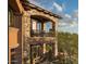 Stone and stucco exterior with a wrought iron balcony at 9808 E Honey Mesquite Dr, Scottsdale, AZ 85262
