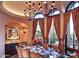 Formal dining room with large windows, chandelier, and seating for eight at 9808 E Honey Mesquite Dr, Scottsdale, AZ 85262