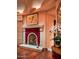Fireplace with a red leather mantel and hardwood floors at 9808 E Honey Mesquite Dr, Scottsdale, AZ 85262