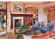 Living room with a stunning fireplace, built-in shelving, and comfortable seating at 9808 E Honey Mesquite Dr, Scottsdale, AZ 85262
