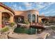 Backyard oasis with a pond, bridge and patio at 9808 E Honey Mesquite Dr, Scottsdale, AZ 85262