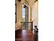 Elegant landing with hardwood floors, wrought iron railing, and a view at 9808 E Honey Mesquite Dr, Scottsdale, AZ 85262