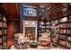 Grand library with built-in bookshelves and fireplace at 9808 E Honey Mesquite Dr, Scottsdale, AZ 85262
