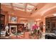 Elegant living room with a fireplace, high ceilings, and access to outdoor patio at 9808 E Honey Mesquite Dr, Scottsdale, AZ 85262