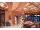 Spacious living room with high ceilings, ornate fireplace, and large windows at 9808 E Honey Mesquite Dr, Scottsdale, AZ 85262