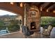 Covered patio with fireplace and seating area, mountain views at 9808 E Honey Mesquite Dr, Scottsdale, AZ 85262