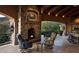 Spacious covered patio with fireplace and dining area at 9808 E Honey Mesquite Dr, Scottsdale, AZ 85262