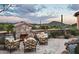 Relaxing patio with fireplace, seating, and mountain views at 9808 E Honey Mesquite Dr, Scottsdale, AZ 85262