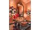 Powder room with unique sink and ornate mirror at 9808 E Honey Mesquite Dr, Scottsdale, AZ 85262
