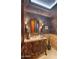 Ornate powder room with patterned wallpaper and vanity at 9808 E Honey Mesquite Dr, Scottsdale, AZ 85262