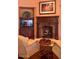 Cozy sitting area with a fireplace and two armchairs at 9808 E Honey Mesquite Dr, Scottsdale, AZ 85262