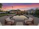 Stunning desert landscape with a pool and modern seating area at 5815 N Kiva Ln, Paradise Valley, AZ 85253
