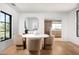 Modern dining room with round table and view of the kitchen at 5815 N Kiva Ln, Paradise Valley, AZ 85253