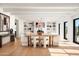 Bright dining room with a large wooden table and white chairs, hardwood floors and built-in shelving at 5815 N Kiva Ln, Paradise Valley, AZ 85253
