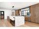 Modern kitchen with large island, wood cabinets, and marble countertops at 5815 N Kiva Ln, Paradise Valley, AZ 85253