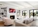 Spacious living room with a fireplace, comfortable seating, and large windows offering natural light at 5815 N Kiva Ln, Paradise Valley, AZ 85253