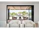 View of the backyard pool from the living room through large doors at 5815 N Kiva Ln, Paradise Valley, AZ 85253