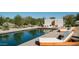 Inviting pool with wooden lounge chairs and a modern design at 5815 N Kiva Ln, Paradise Valley, AZ 85253