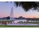 Scenic view of a lake with fountain, mountains, and sunset at 10401 N Saguaro Blvd # 224, Fountain Hills, AZ 85268
