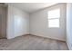 Well-lit bedroom featuring carpet floors and a window at 35560 W La Paz St, Maricopa, AZ 85138