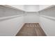Spacious walk-in closet with ample storage and neutral carpet at 35560 W La Paz St, Maricopa, AZ 85138