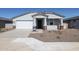 New single-story home with white garage door and brick accents at 35560 W La Paz St, Maricopa, AZ 85138