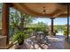 Covered patio with seating area and tranquil garden views at 29630 N 107Th Pl, Scottsdale, AZ 85262