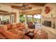 Open living area with fireplace, patio access, and southwestern decor at 29630 N 107Th Pl, Scottsdale, AZ 85262