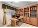 Bright home office with built-in shelving and large desk at 2754 W Tanner Ranch Rd, San Tan Valley, AZ 85144