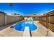 Refreshing blue pool with diving board and fenced yard at 4141 W Pasadena Ave, Phoenix, AZ 85019