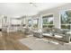 Open concept kitchen and living area with light wood floors and white cabinetry at 8757 E Lariat Ln, Scottsdale, AZ 85255