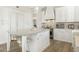 White kitchen features a large island with marble countertop and stainless steel appliances at 8757 E Lariat Ln, Scottsdale, AZ 85255