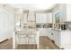 Modern white kitchen with a large island and marble countertops at 8757 E Lariat Ln, Scottsdale, AZ 85255