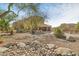 Beautiful home exterior with a landscaped yard and rock garden at 8757 E Lariat Ln, Scottsdale, AZ 85255
