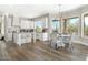 Open concept kitchen with white cabinets, a center island, and a dining area at 8757 E Lariat Ln, Scottsdale, AZ 85255