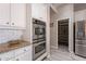 Bright kitchen with granite countertops, stainless steel appliances, and a walk-in pantry at 1912 E Gemini Pl, Chandler, AZ 85249
