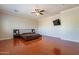 Main bedroom with hardwood floors, a large TV, and plenty of space at 1912 E Gemini Pl, Chandler, AZ 85249
