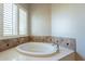 Relaxing bathroom with large soaking tub and plantation shutters at 1912 E Gemini Pl, Chandler, AZ 85249