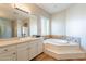 Spa-like bathroom with soaking tub, double vanity, and updated fixtures at 1912 E Gemini Pl, Chandler, AZ 85249