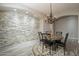 Formal dining room with stone accent wall and chandelier at 1912 E Gemini Pl, Chandler, AZ 85249
