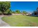 Expansive backyard with lush lawn, trees, and a walkway at 1912 E Gemini Pl, Chandler, AZ 85249